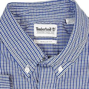 (12) Men’s medium weight button down Timberland shirts in various patterns.